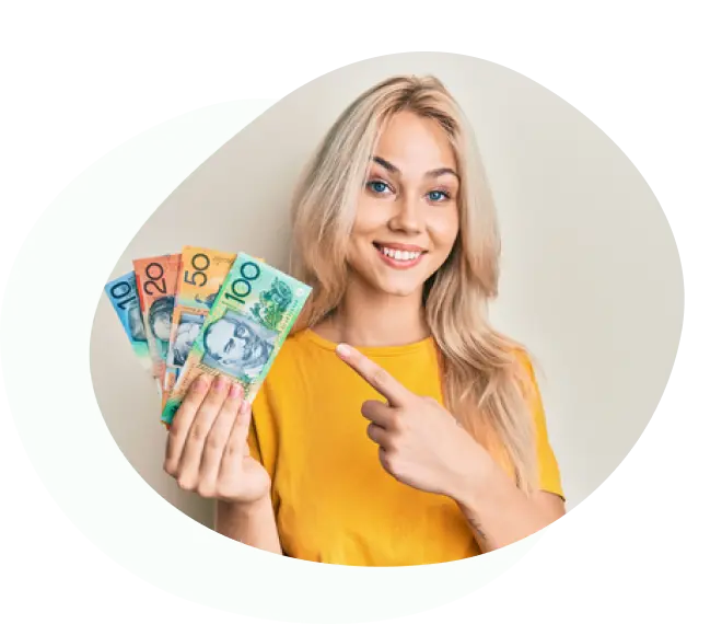 Blonde woman in yellow top pointing excitedly at cash