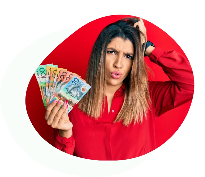 Confused woman in red holding Australian banknotes