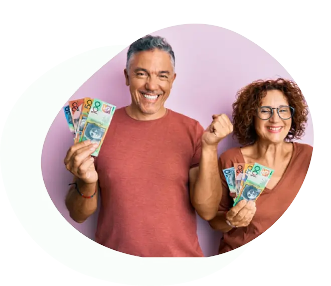 Smiling couple holding Australian banknotes and celebrating