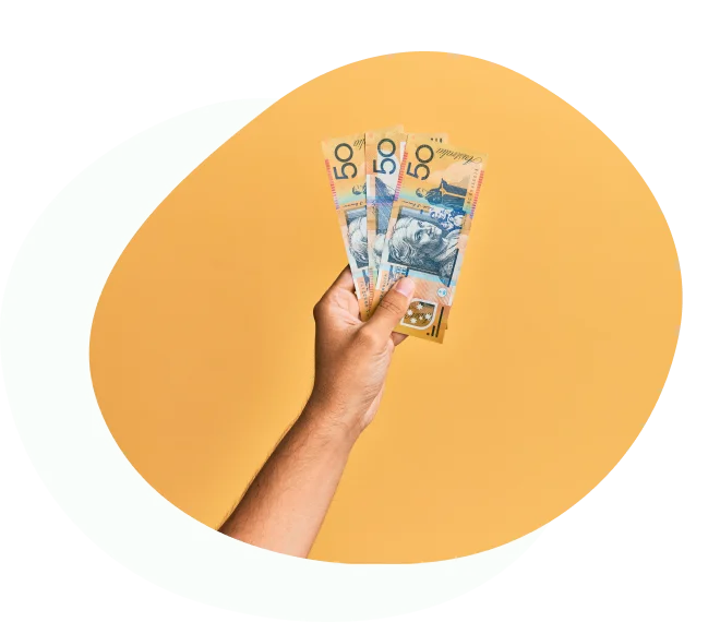 Hand holding three Australian fifty-dollar notes against yellow background