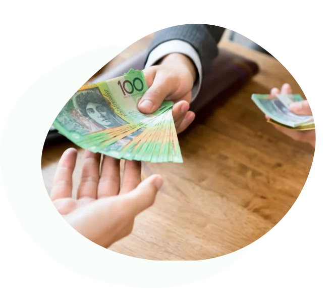 Person handing over a stack of Australian hundred-dollar notes