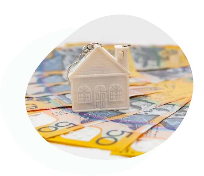 House keychain placed on Australian banknotes, symbolising home loan