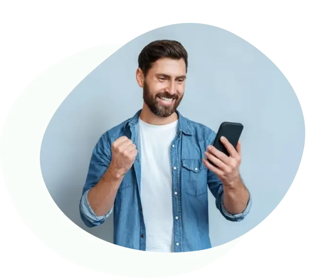 Bearded man smiling while checking his phone